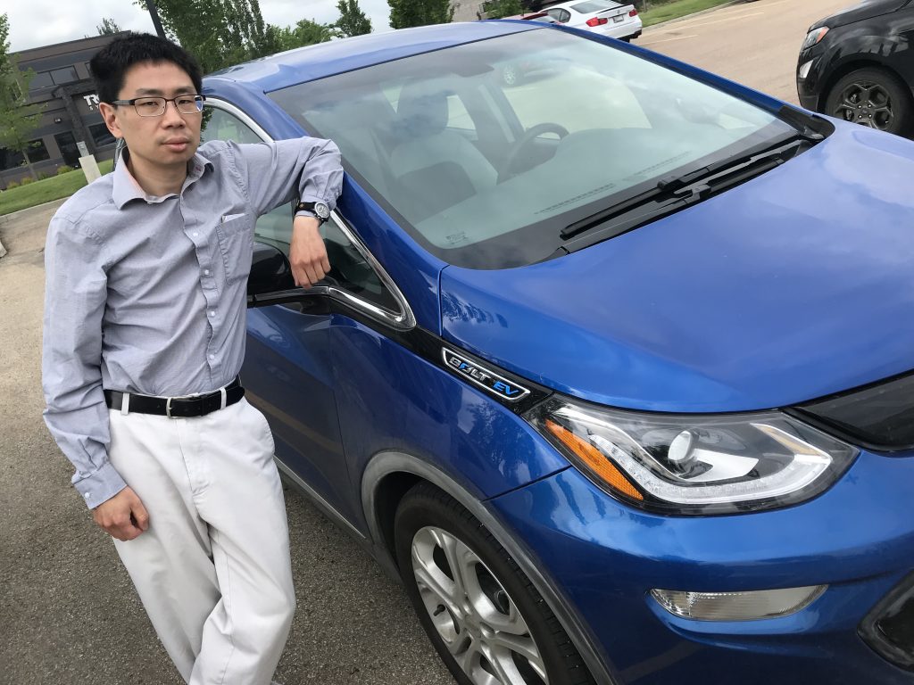 Kevin Ma with his Chevy Bolt electric vehicle.